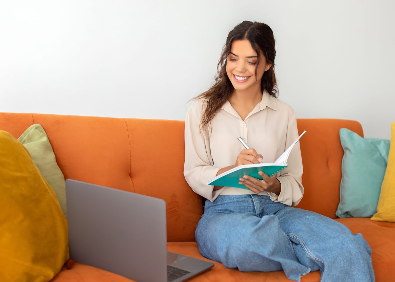 58483894_young-smiling-beautiful-woman-taking-notes-while-study-with-laptop-at-home.jpg