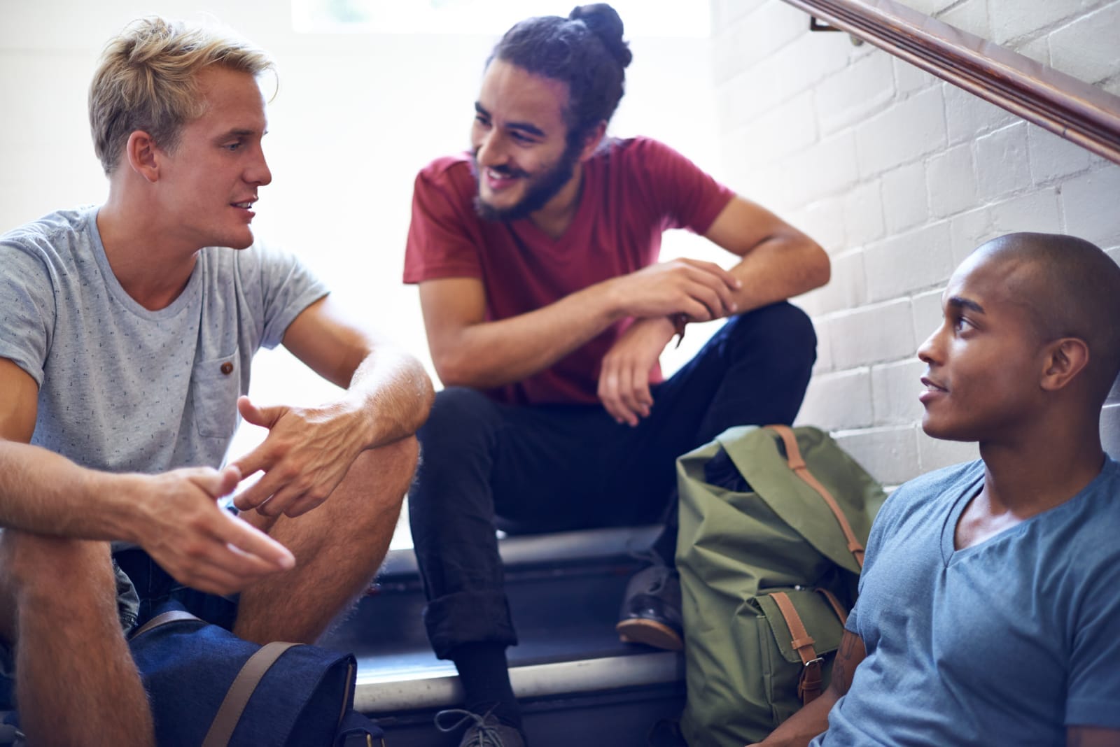 58223284_happy-man-student-and-friends-talking-on-stairs-with-group-for-conversation-social-interaction-or-chat-at-campus-university-people-or-male-person-with-smile-on-staircase-for-discussion-at-college.jpg