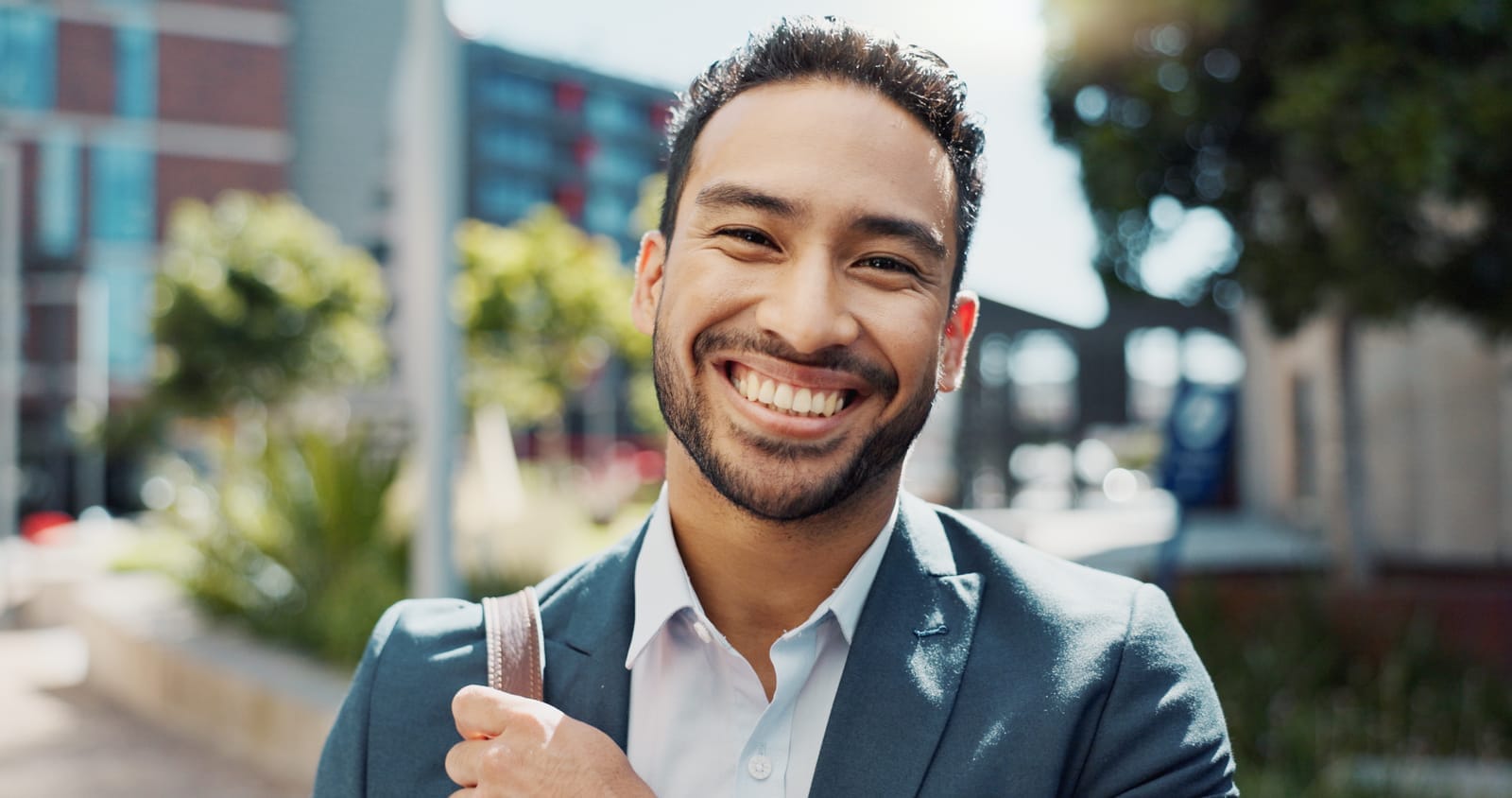 57798868_face-happy-and-business-man-in-city-outdoor-in-the-morning-for-travel-commute-or-trip-portrait-smile-and-professional-lawyer-in-town-attorney-and-employee-working-in-mexico-for-career-or-job.jpg