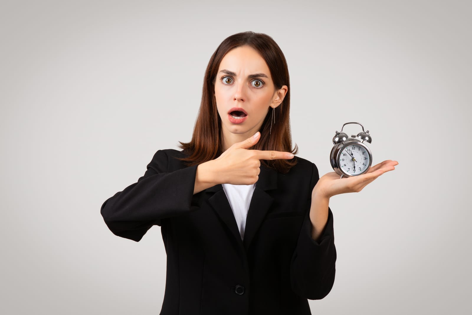 58211390_shocked-young-businesswoman-in-a-black-blazer-expressing-urgency-or-time-management-issues.jpg