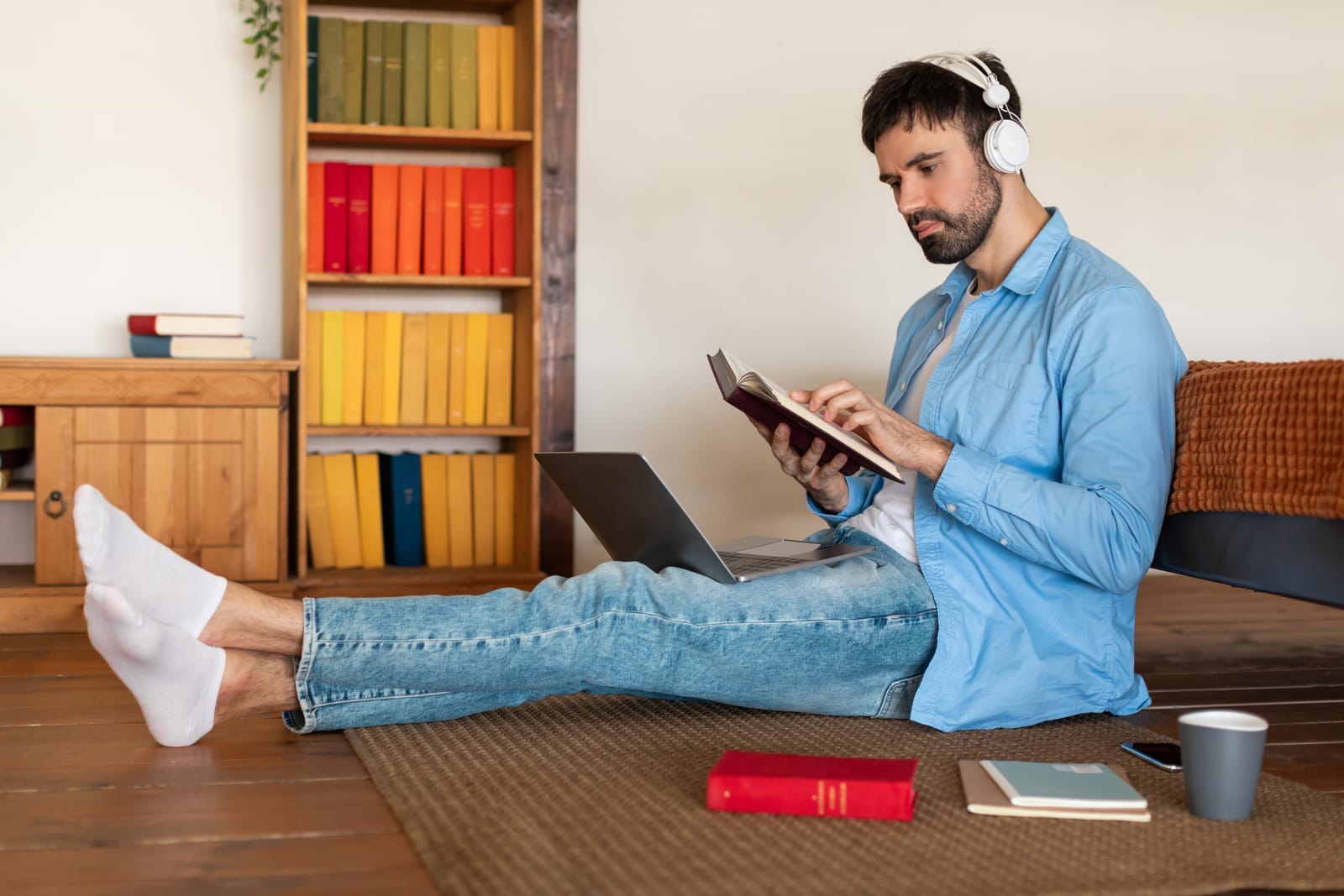 59453636_young-man-reading-book-and-listening-to-music-at-home.jpg