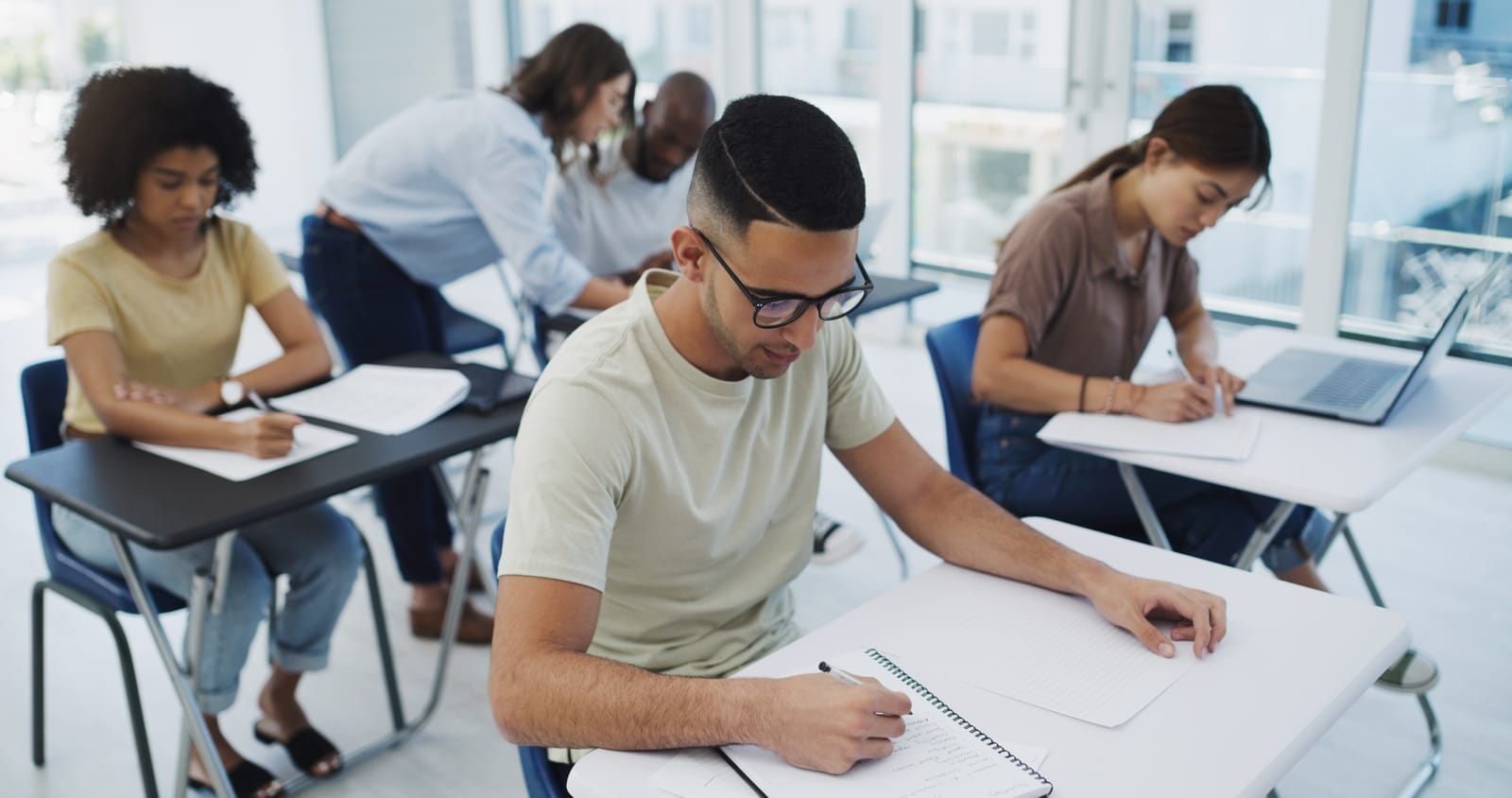 59258874_education-exam-and-university-students-with-diversity-in-classroom-for-learning-test-or-studying-young-people-writing-and-college-learner-together-for-scholarship-for-future-career-or-development.jpg