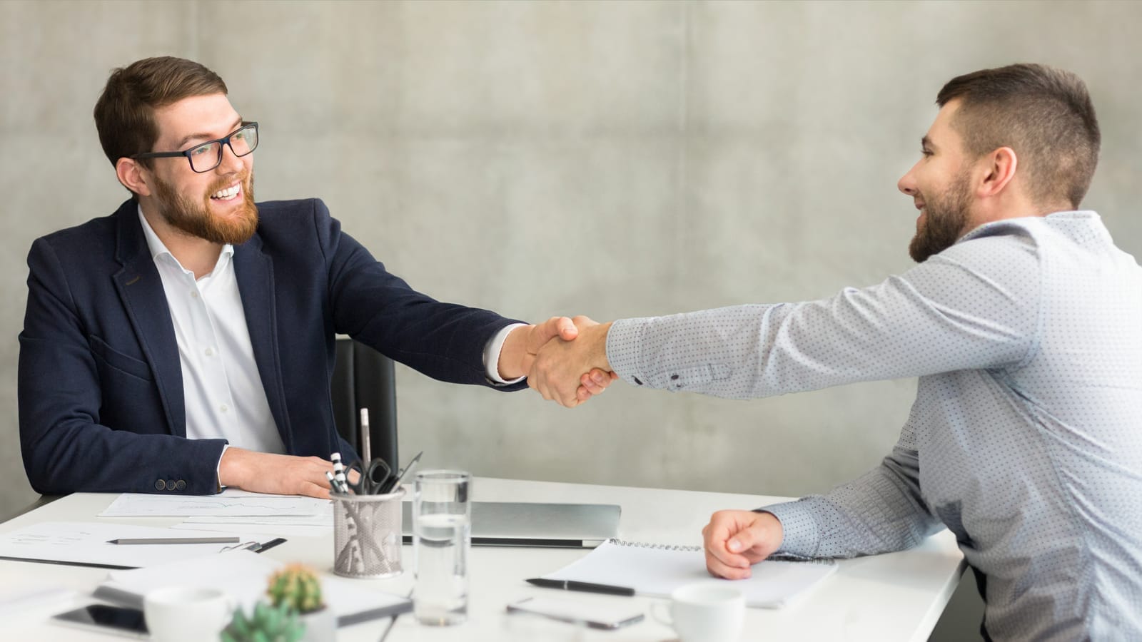 58955720_businessmen-shaking-hands-in-office-setting-successful-deal.jpg